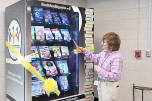 Amy Smith cuts ribbon  on Whitfield Book Vending Machine